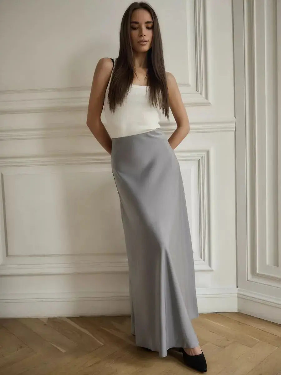 Flowing minimalist fishtail maxi skirt, high-waisted for a refined evening.