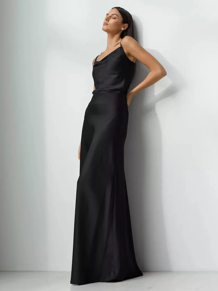 Graceful black maxi skirt, high-waisted fishtail design, suitable for formal occasions.