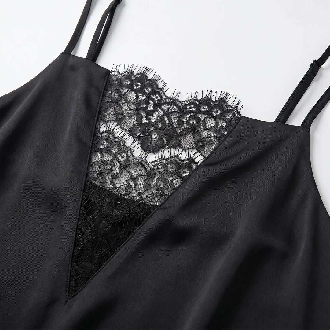 Stylish black women's slip dress featuring intricate lace trim and spaghetti straps. Elegant mini dress for evening wear.
