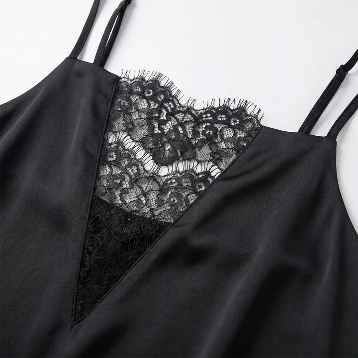 Stylish black women's slip dress featuring intricate lace trim and spaghetti straps. Elegant mini dress for evening wear.