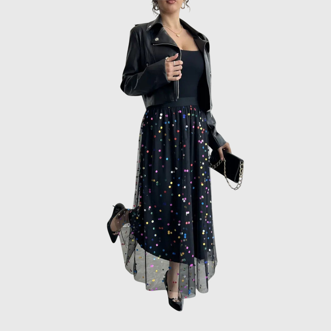 Close-up of a shimmering black sequin midi skirt, showcasing its elegant texture and modern asymmetric design.