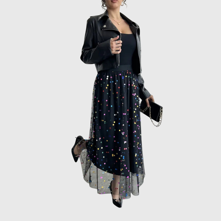 Close-up of a shimmering black sequin midi skirt, showcasing its elegant texture and modern asymmetric design.