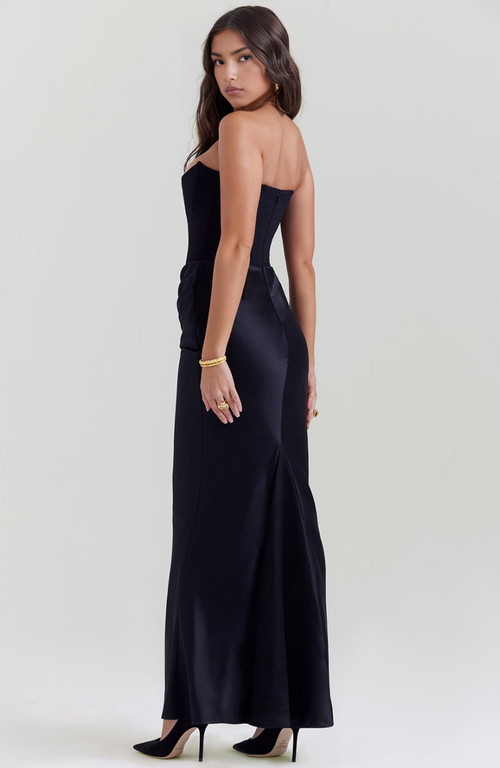 Black strapless maxi wedding guest dress with a flattering corset bodice design.