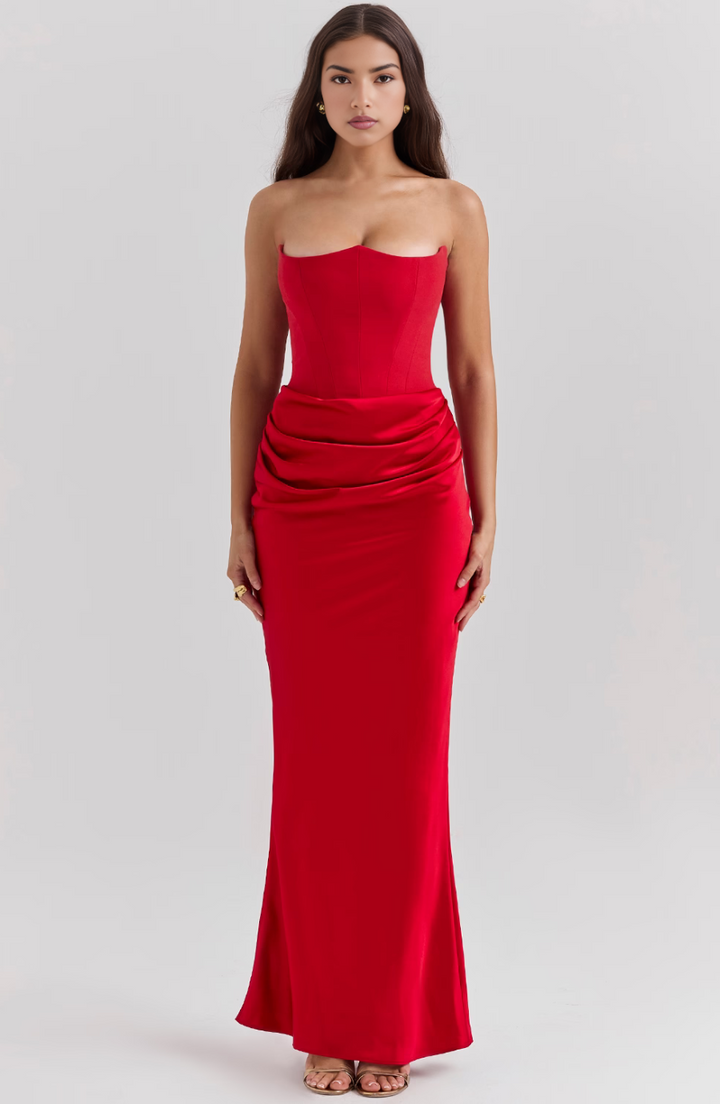 Emerald green formal strapless maxi dress with corset detail, chic party attire.
