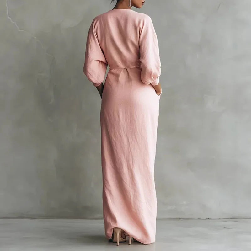 Flattering pink V-neck wrap maxi dress for women. Elegant long sleeve design, perfect for day or evening.