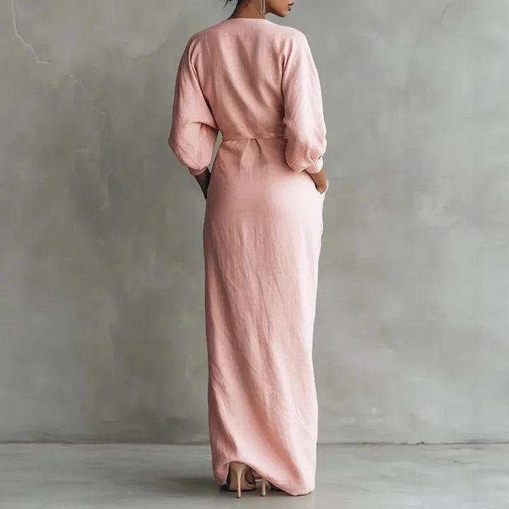Flattering pink V-neck wrap maxi dress for women. Elegant long sleeve design, perfect for day or evening.