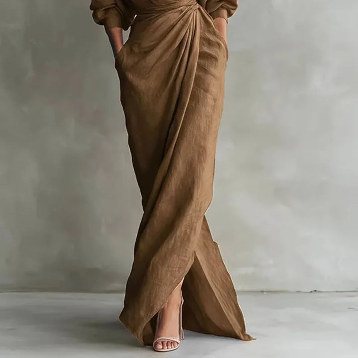 Black bodycon V-neck wrap maxi dress. Versatile long sleeve style, ideal for elegant day or evening events.