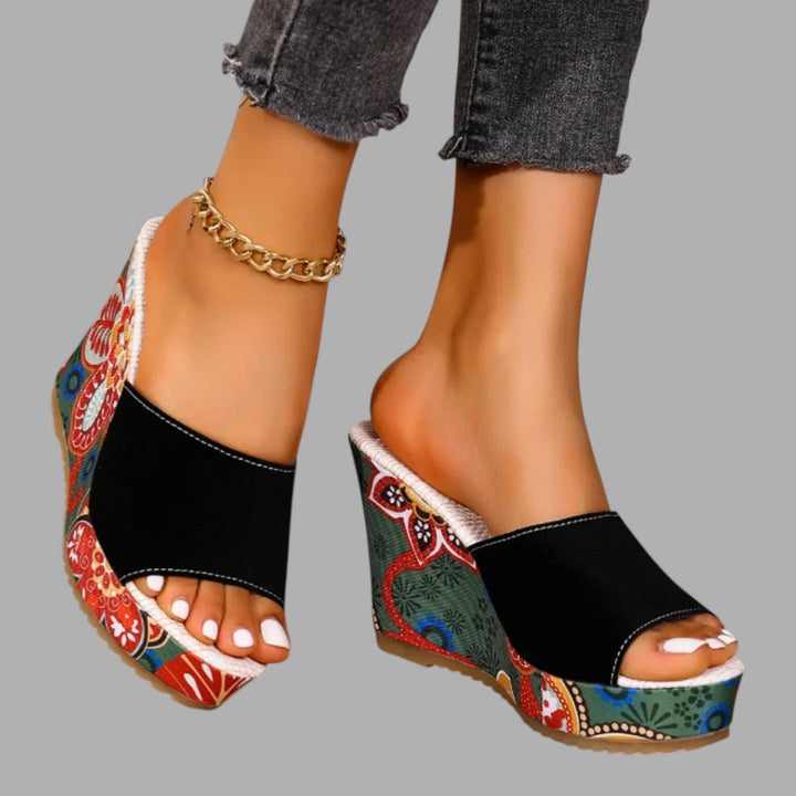 Sophisticated ladies' heeled wedge sandals, designed for comfortable and elegant summer occasion wear.