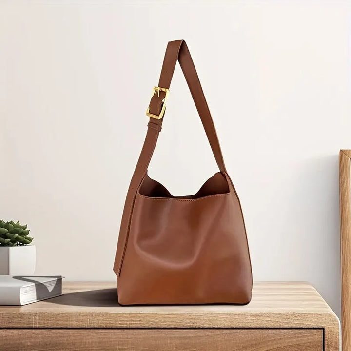 Elegant brown women's shoulder bag, versatile for everyday fashion & daily essentials. Chic accessory.