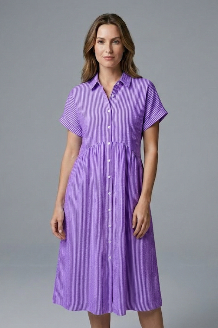 Woman wearing a flattering button-front collared midi dress, exuding elegant summer & office style.