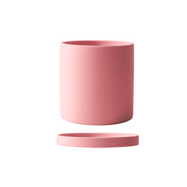 Sleek ceramic indoor plant pot with a matte finish and functional drainage saucer.