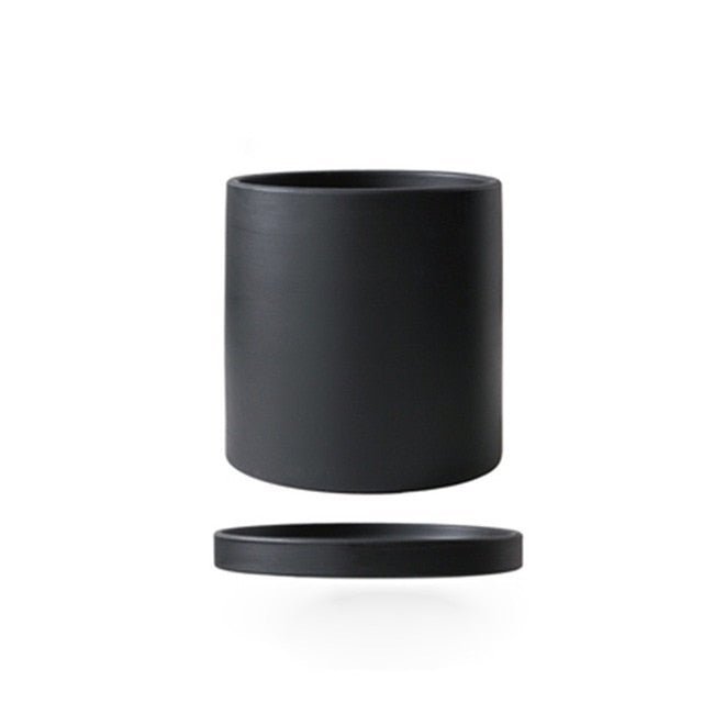 Decorative ceramic planter with saucer, bringing style to your indoor plant collection.