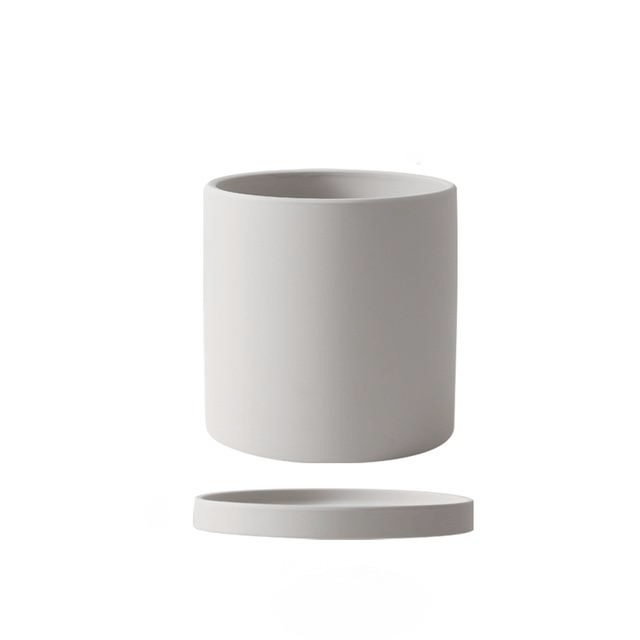 Refined ceramic plant holder with drainage saucer, ideal for your favorite indoor plants.