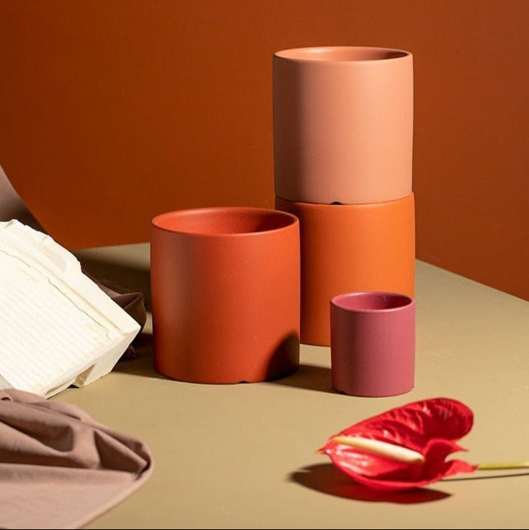 Matte finish ceramic planter with saucer, a sophisticated plant holder for any indoor space.