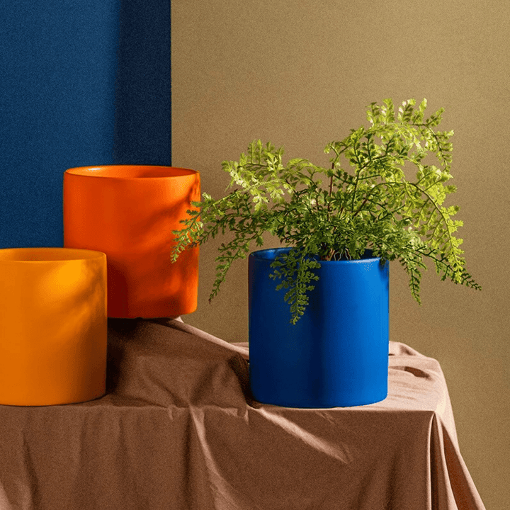 High-quality ceramic indoor plant pot with saucer, designed for elegant plant display.