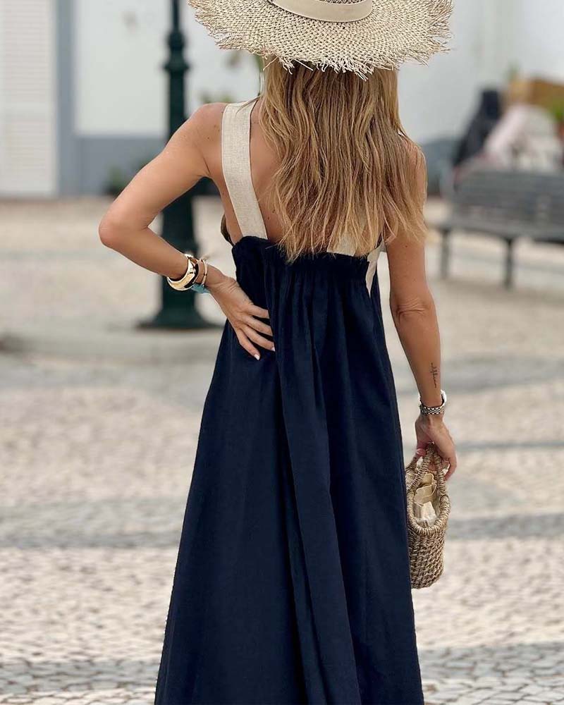 Sleeveless black cross-neck elegant summer dress. Chic A-line design for women's vacation fashion.