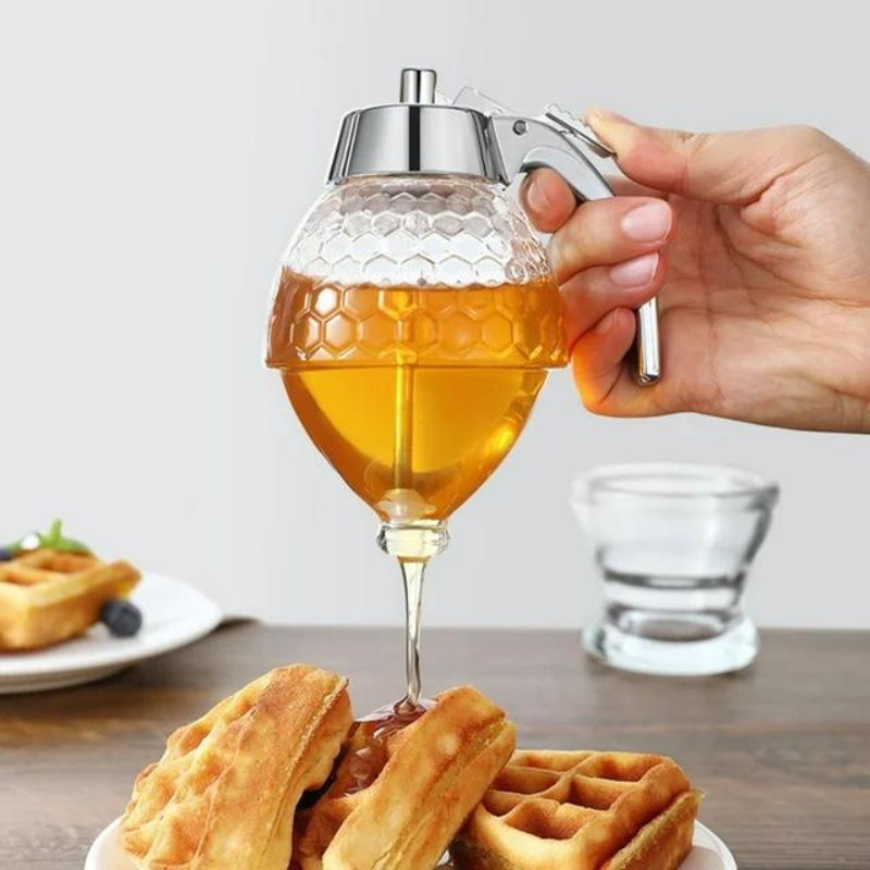 Elegant clear plastic drip-free honey dispenser for kitchen. Perfect for syrups, breakfast, and clean serving.