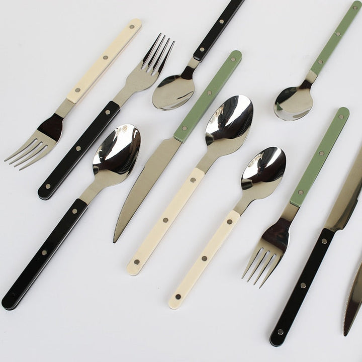 24-piece stainless steel flatware set featuring elegant engraved patterns.