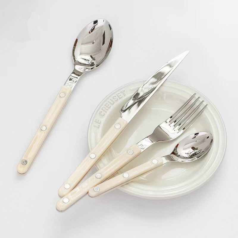 Modern engraved flatware, a 24-piece stainless steel dinnerware set.