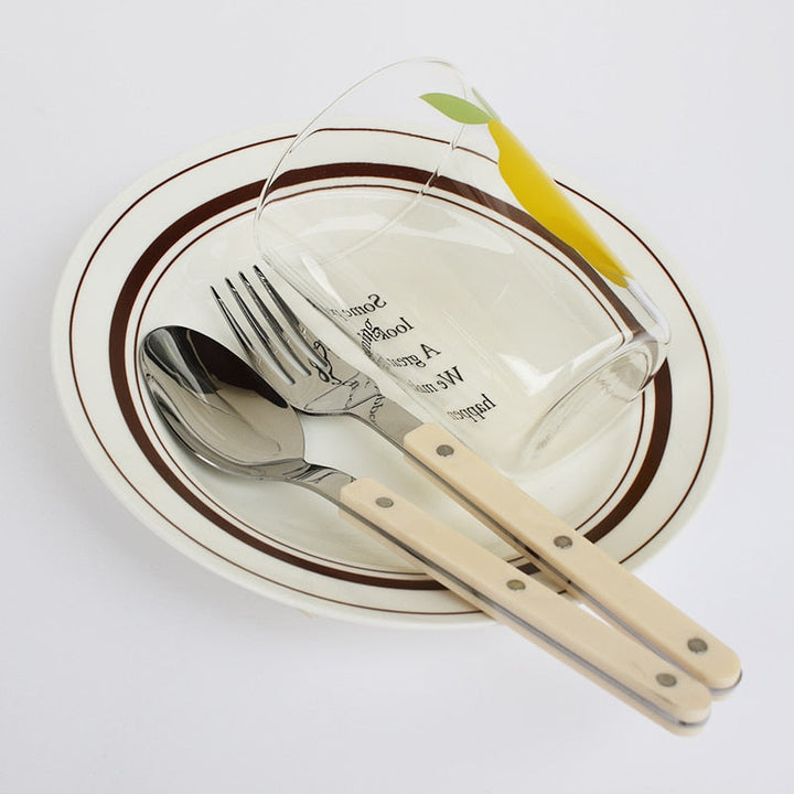 Complete 24-piece engraved stainless steel dining set for elegant meals.