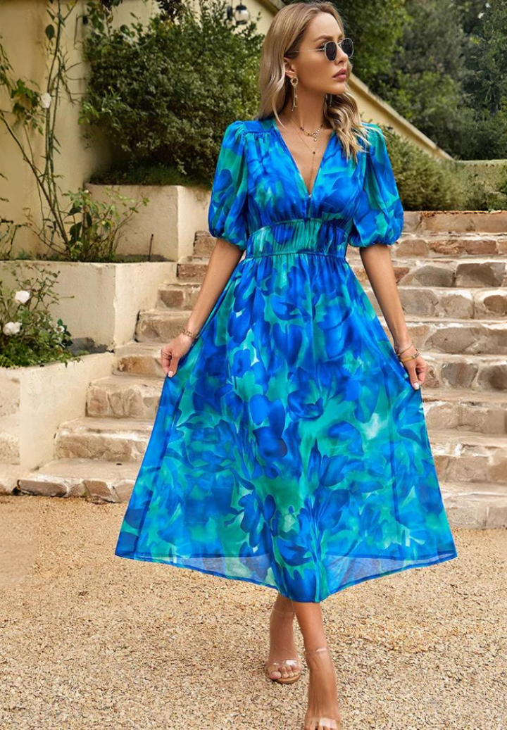 Elegant women's midi dress showcasing a vibrant floral print, puff sleeves, and a flattering A-line cut.