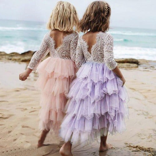 Back view of a girls' elegant lacedress showcasing the backless design and ruffles for parties.