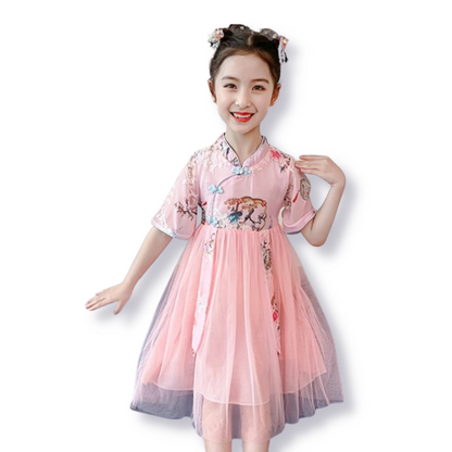 Elegant girls' cheongsam dress featuring a beautiful traditional tree print, perfect for special occasions & cultural wear.