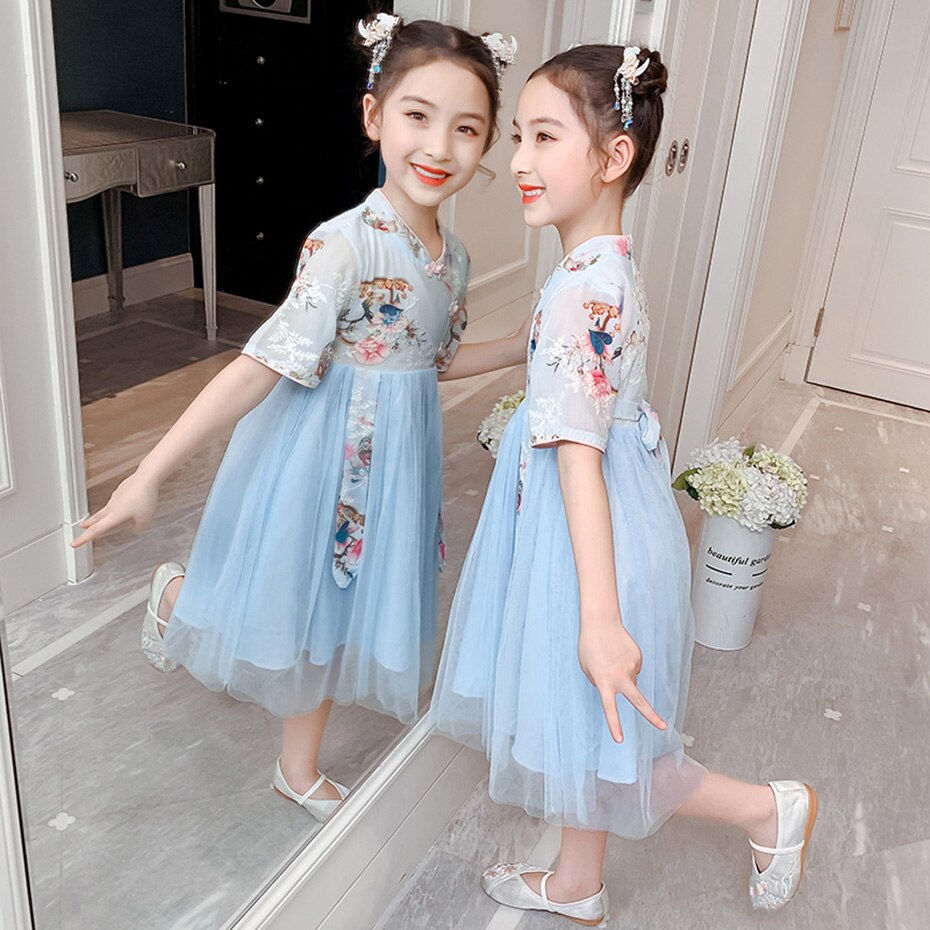 Close-up of a girls' elegant cheongsam dress, showcasing its vibrant traditional tree print and comfortable short sleeves.
