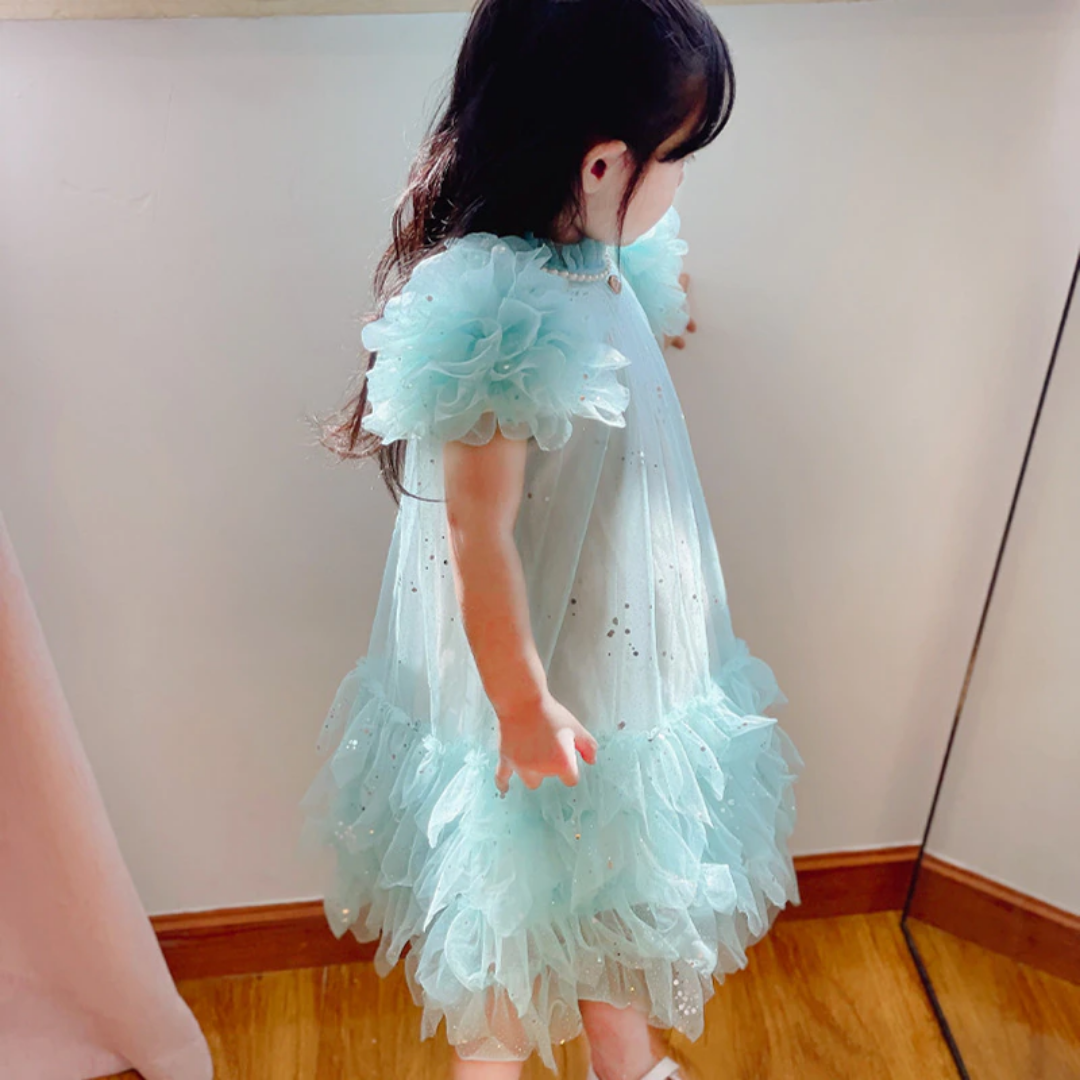 Girls' white party dress with delicate dotted tulle overlay and pretty ruffled sleeves, ideal children's apparel.