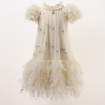 Full-length view of a girls' dotted tulle party dress with ruffle details, ready for a special occasion.
