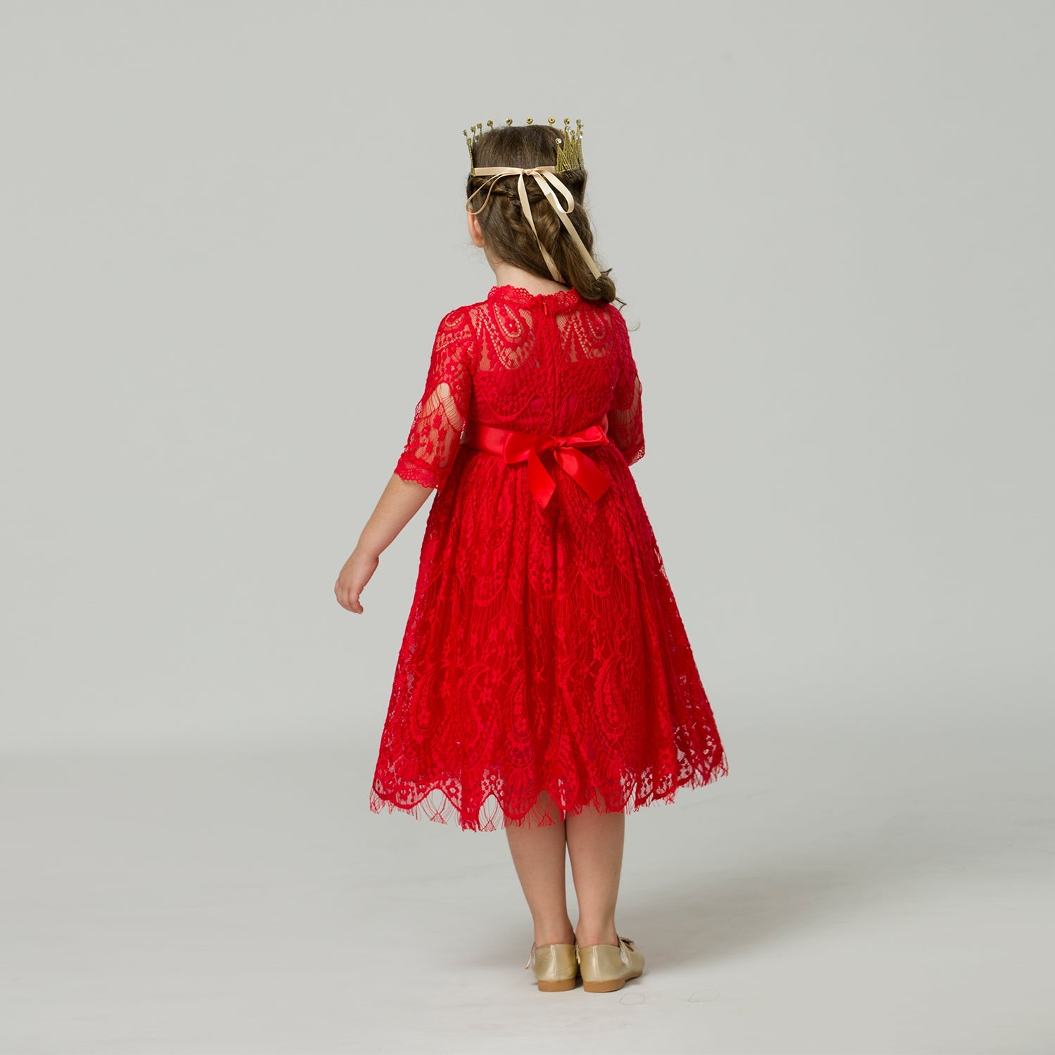 Close-up of delicate lace fabric and satin ribbon on an elegant girls' party dress