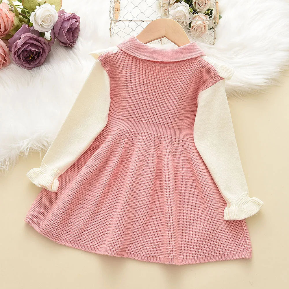 Front view of a girls' pink ruched long sleeve sweater dress, soft acrylic for winter comfort