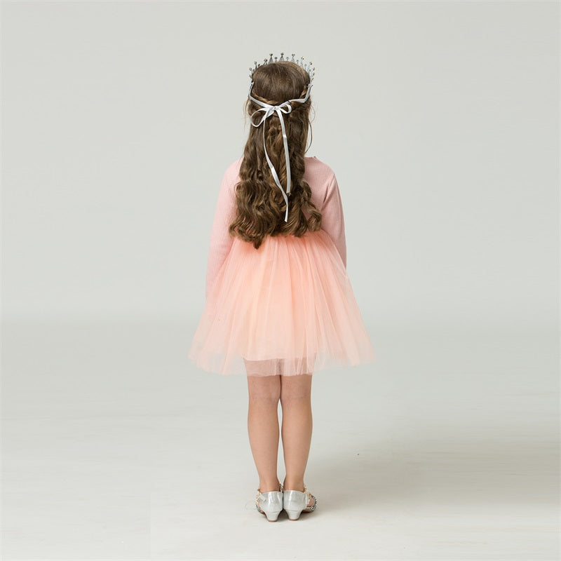 Close-up of girls' long sleeve star mesh dress, highlighting the delicate fabric and star details.