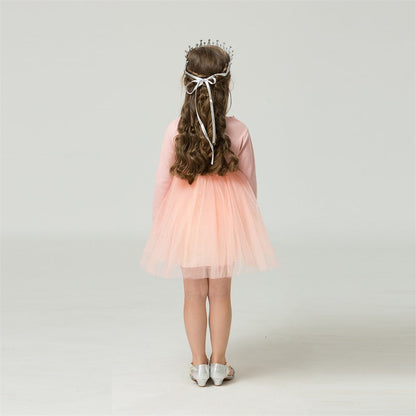 Close-up of girls' long sleeve star mesh dress, highlighting the delicate fabric and star details.