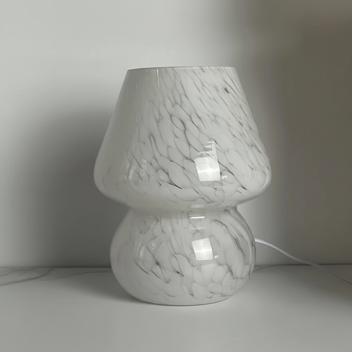 Artistic glass mushroom table lamp, creating a warm glow and enhancing interior design.