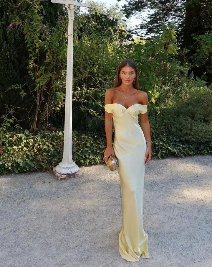 Chic women's gold off-shoulder maxi dress with sweetheart neckline & bias cut, ideal for evening events.