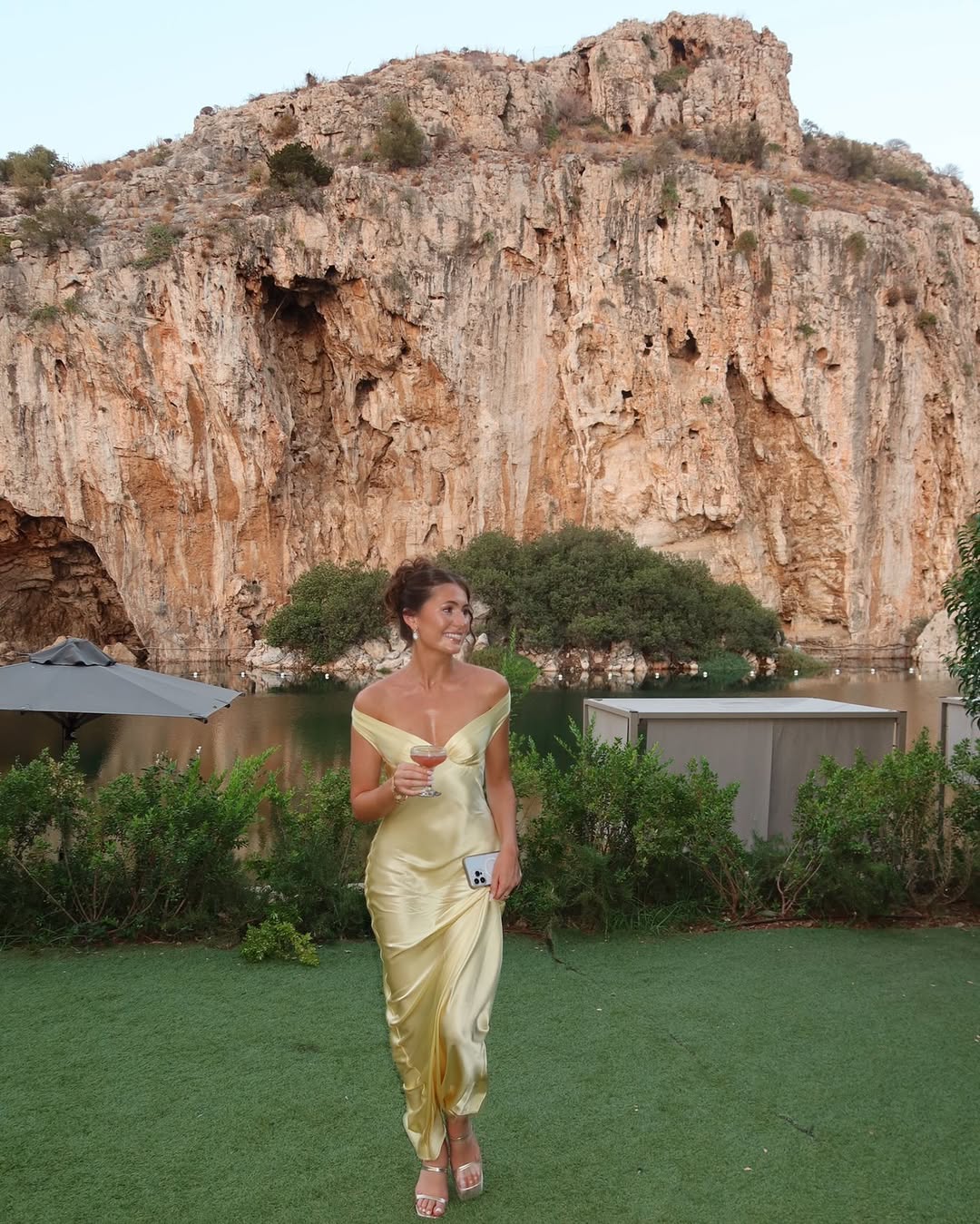 Luxurious gold off-shoulder maxi dress, an elegant evening gown for women attending weddings or galas.