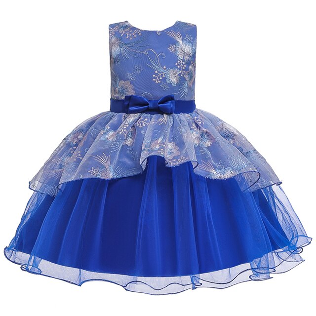Full-length view of a girl wearing a stylish tulle princess ball gown, side profile.