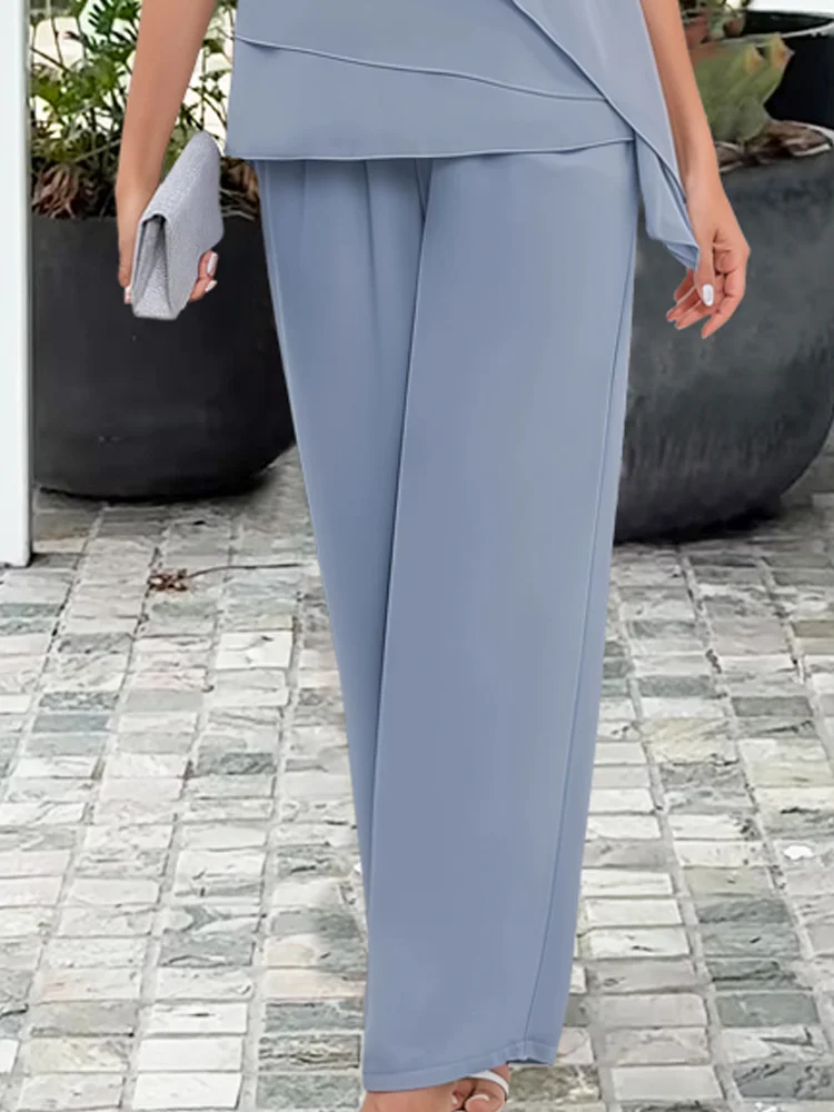 Elegant navy women's cape top and trouser formal wear set, perfect for wedding guest attire.