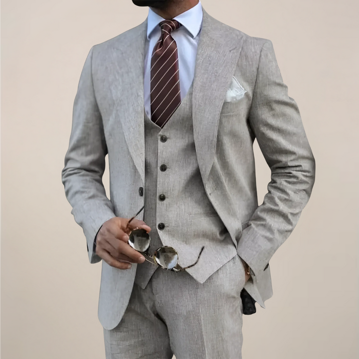 Elegant men's three-piece suit, perfect for formal events, business, or weddings. Includes blazer, waistcoat, & trousers.