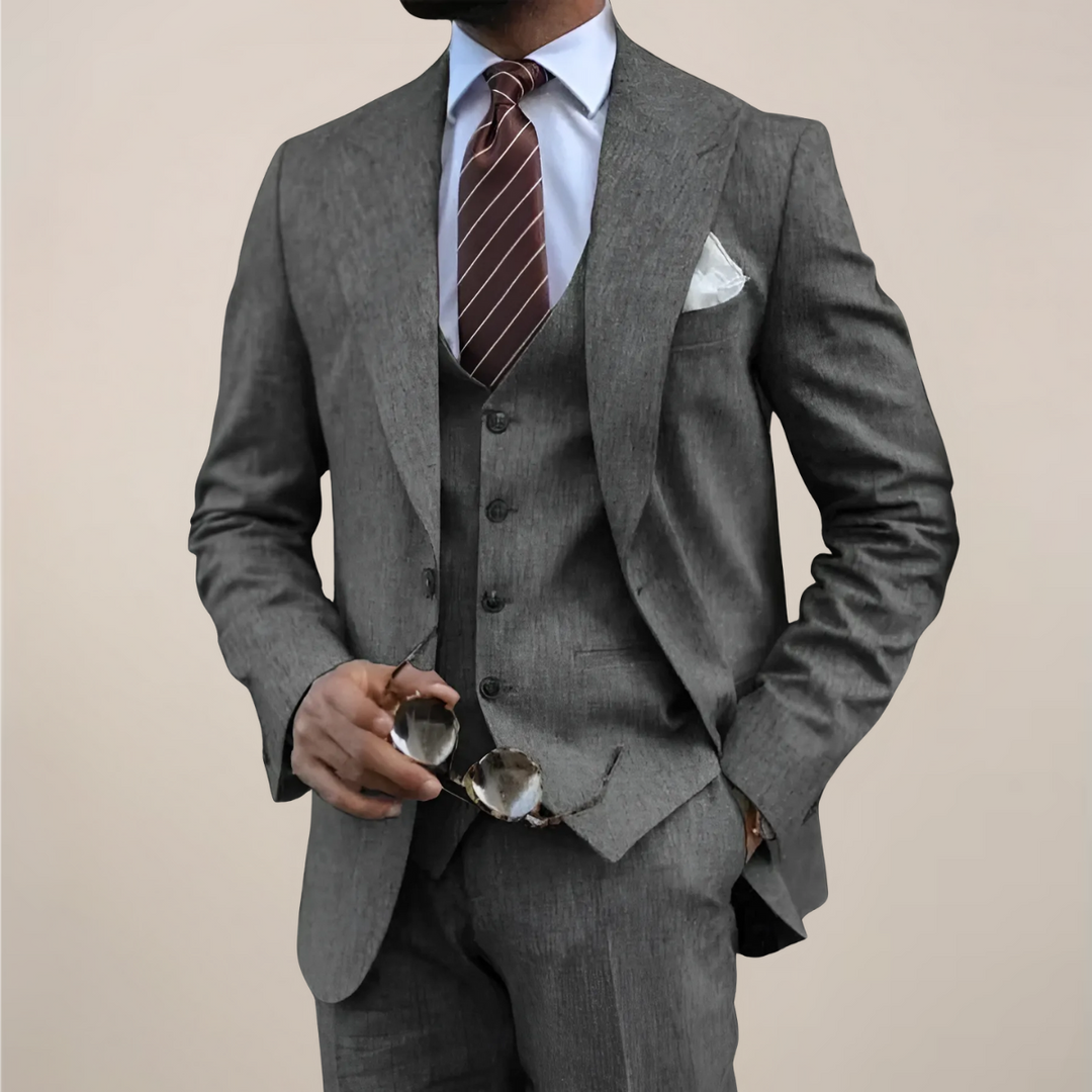 Tailored men's classic three-piece suit with blazer, waistcoat, and trousers for formal & business occasions.