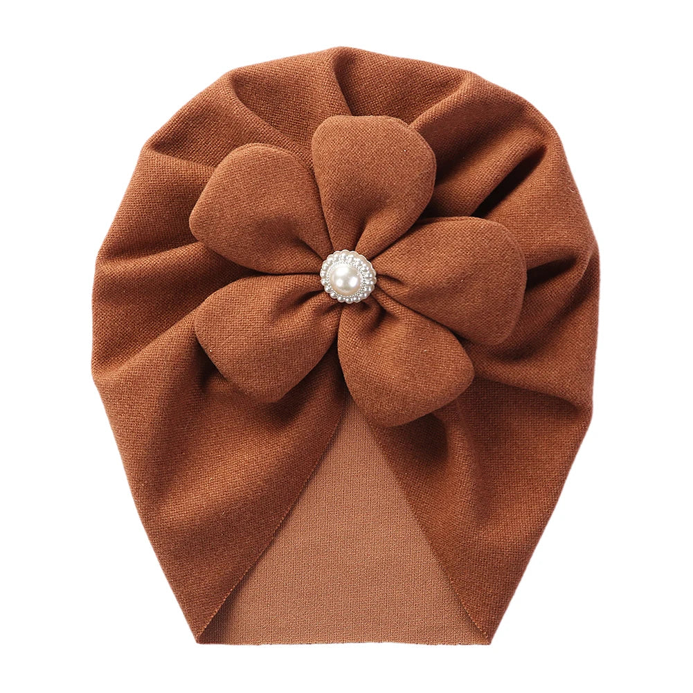 A collection of baby pearl turban hats in various soft colors, perfect for infant accessories.