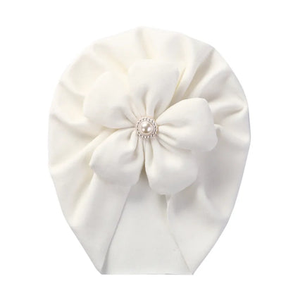 Newborn headwear: a cozy peach turban hat with an elegant pearl flower, a lovely baby gift.