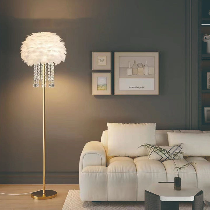 Beautiful feather and crystal floor lamp providing elegant ambient light in a Nordic style living space.