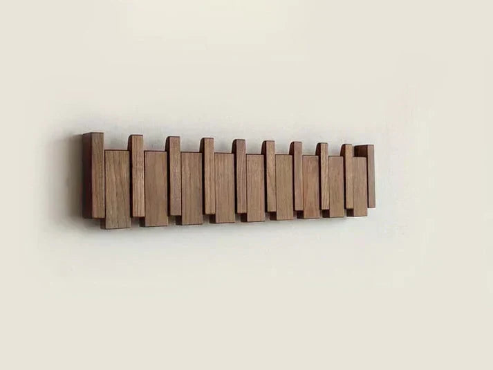 HarmonyCoat elegant piano wall hook rack. Decorative entryway organizer for modern homes & musical theme decor.