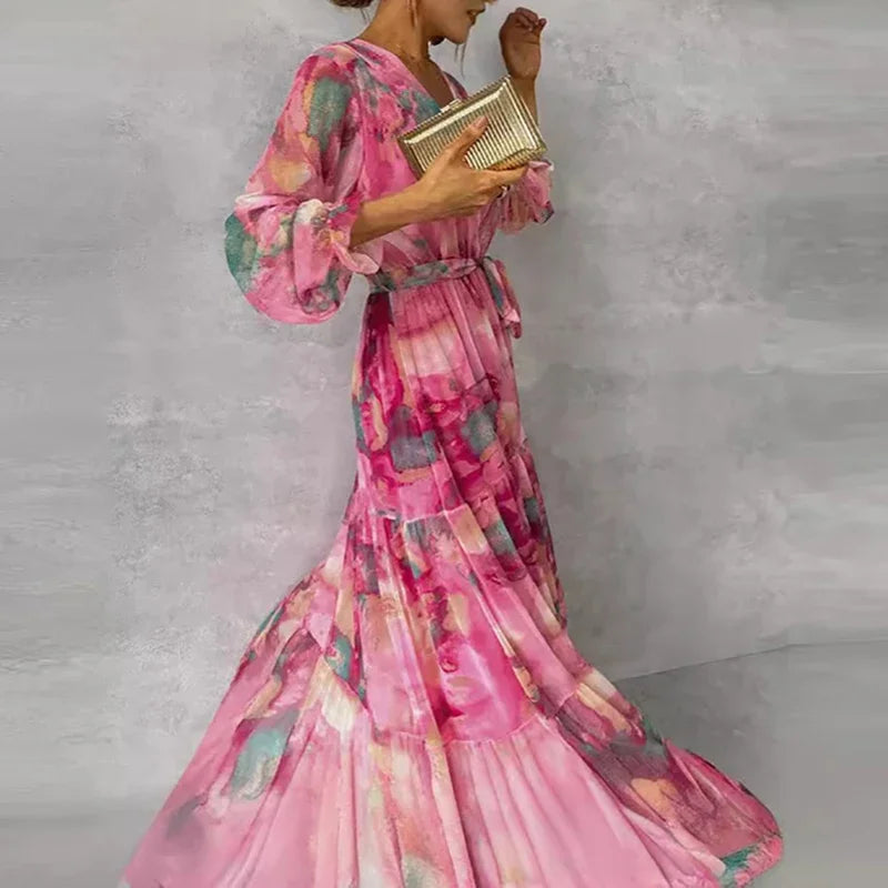 Pink floral V-neck wrap maxi dress for women, featuring a elegant tiered skirt. Ideal long sleeve wedding guest or party dress.