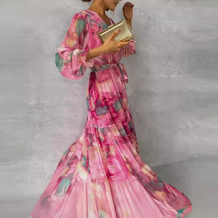 Pink floral V-neck wrap maxi dress for women, featuring a elegant tiered skirt. Ideal long sleeve wedding guest or party dress.