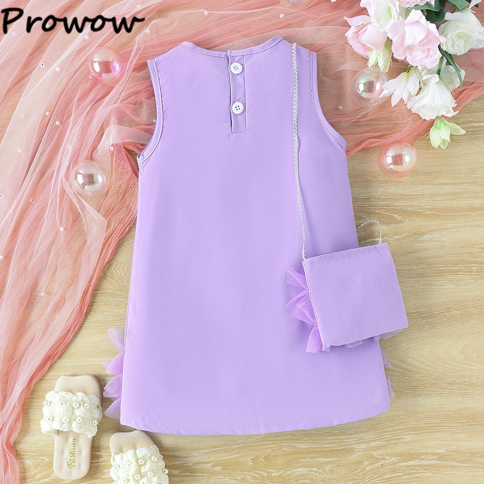 Close-up of girls' elegant purple princess party dress showing intricate detailing and shoulder bag