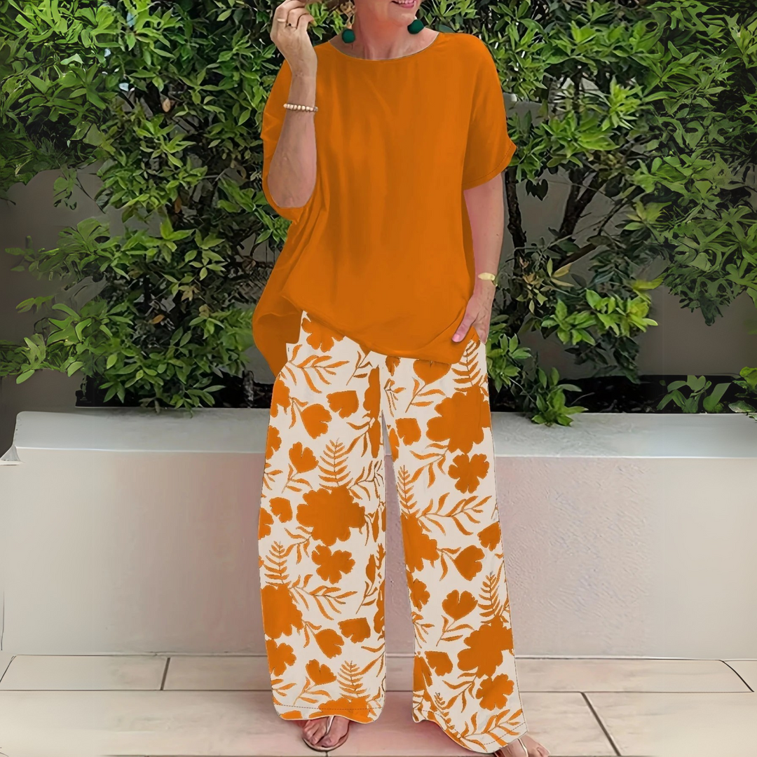 Vibrant floral print plus size two-piece set for women. Elegant wide-leg pants & top matching outfit, versatile.