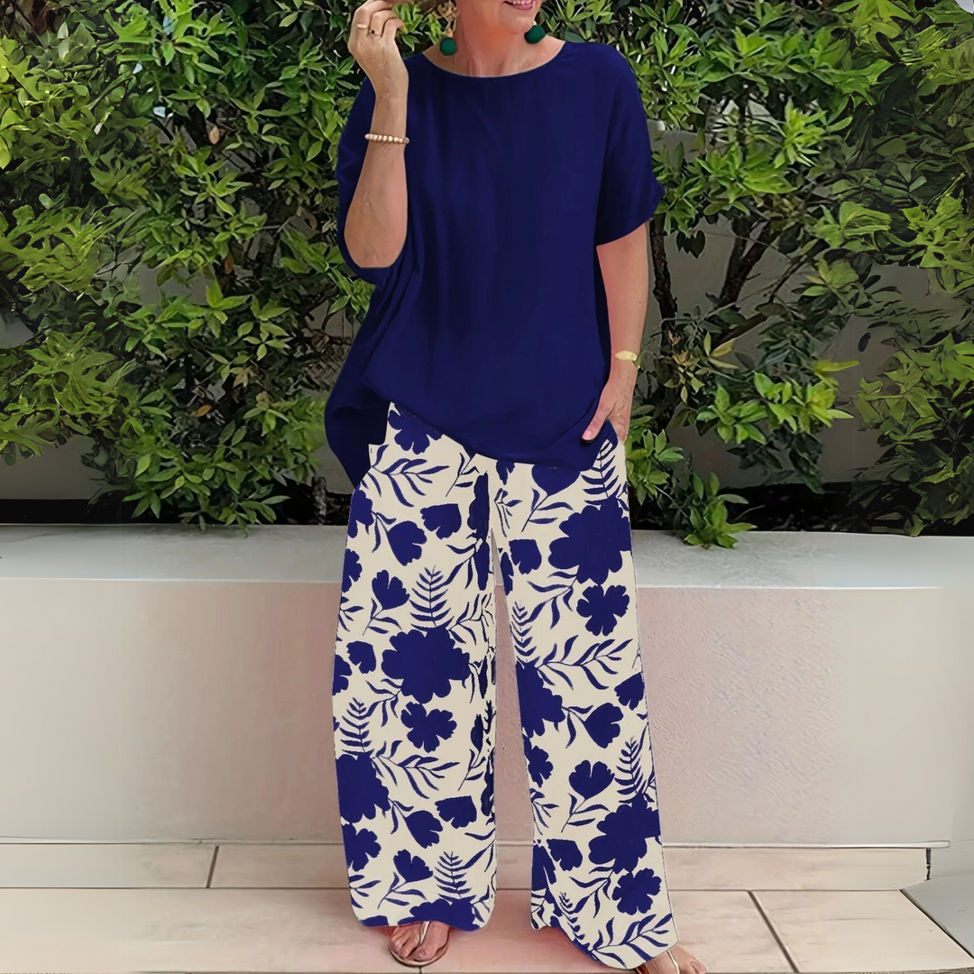 Stylish plus size women's floral two-piece set featuring wide-leg pants. Elegant & comfortable lounge wear outfit.